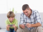格安スマホでゲームを楽しむ!機種選びのポイントとは? Happy father and son playing games on mobile phone at home